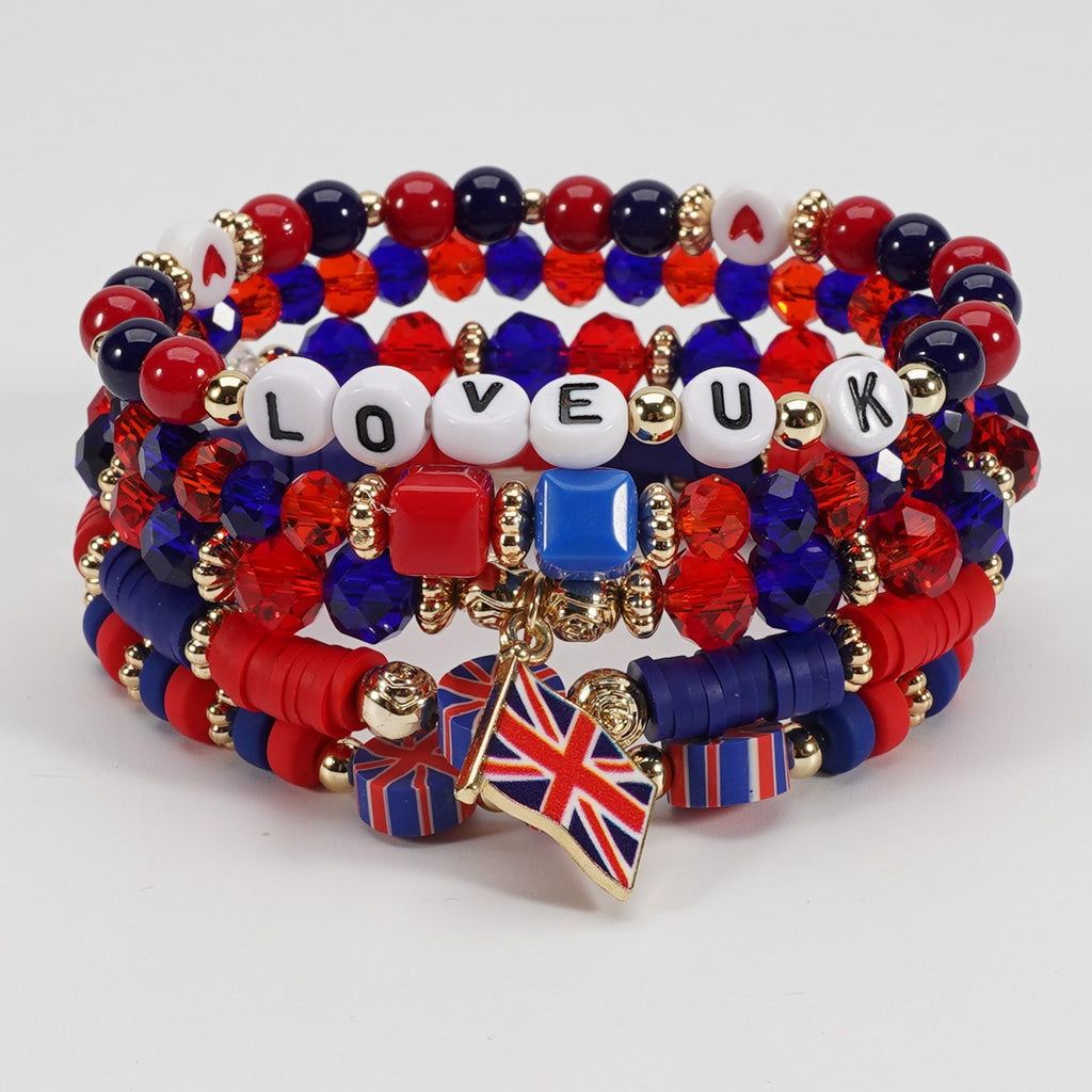 Multistrand bracelet with red, blue, and white beads, gold accents, and a Union Jack charm on a light gray background.