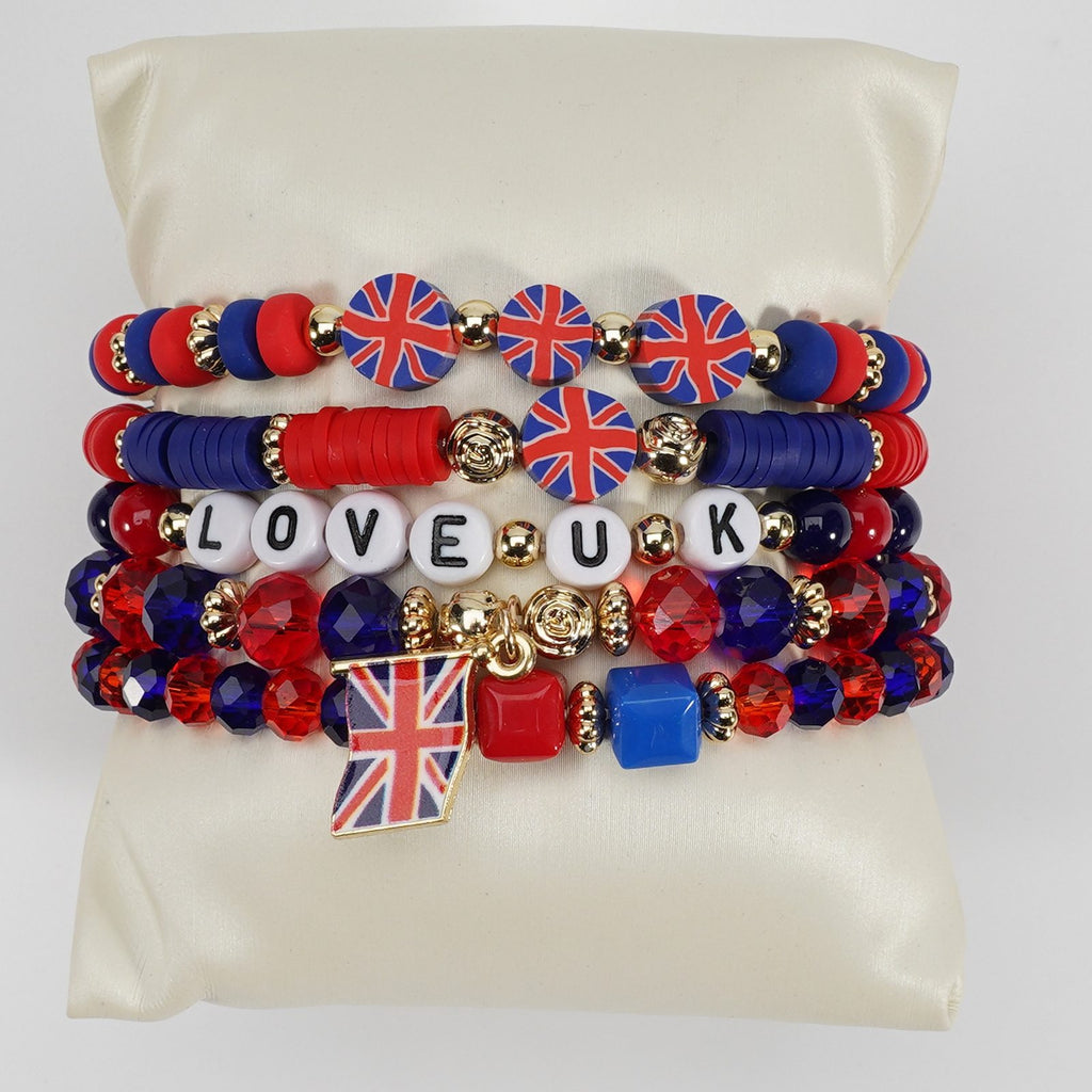 Set of bracelets with Union Jack design and 'LOVE UK' text on a beige pillow.