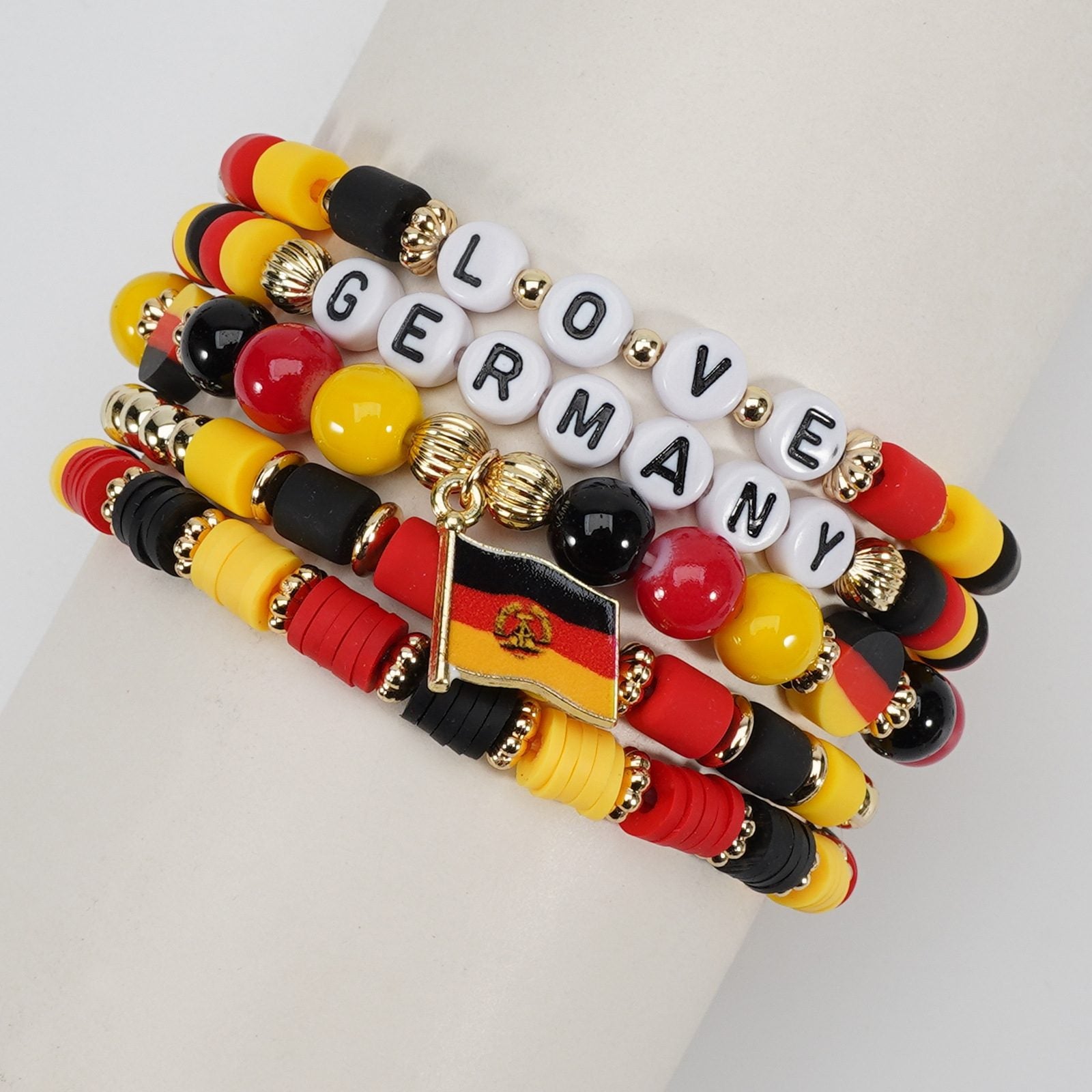 Stack of bracelets with German flag design and 'LOVE GERMANY' text on a white surface