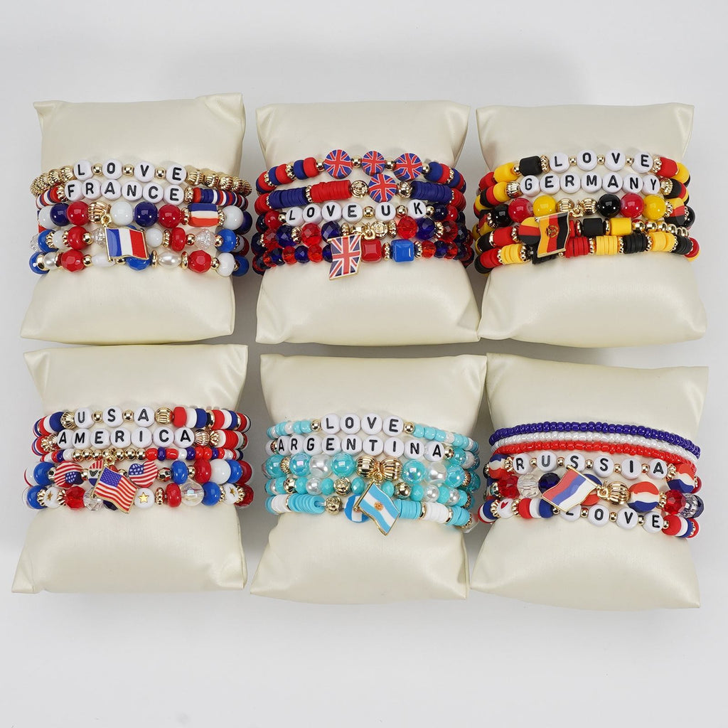 Colorful bracelets with country names and flags on a white background
